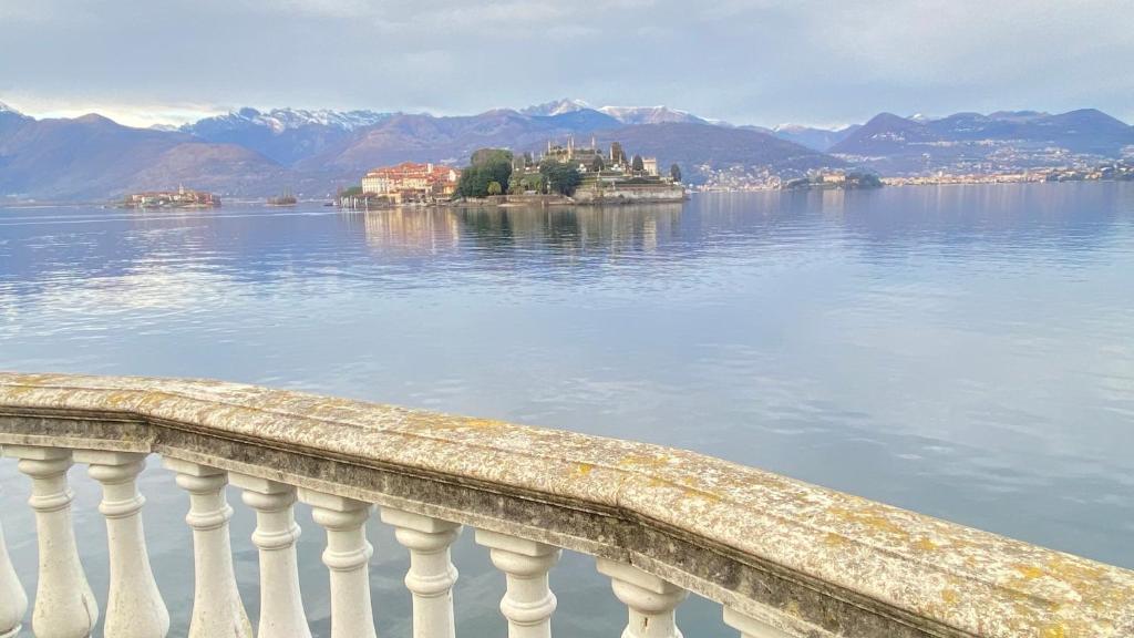a view of a body of water with an island in the water at Family Apartment Vista Lago in Stresa