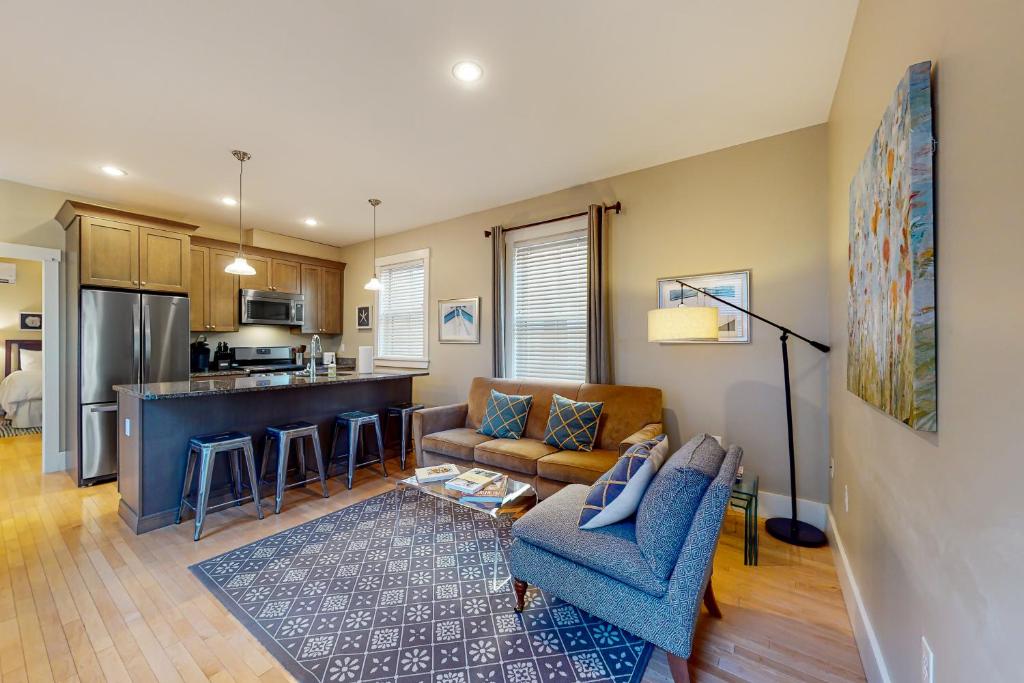a living room with a couch and a kitchen at The Heart of the West End #3 in Portland