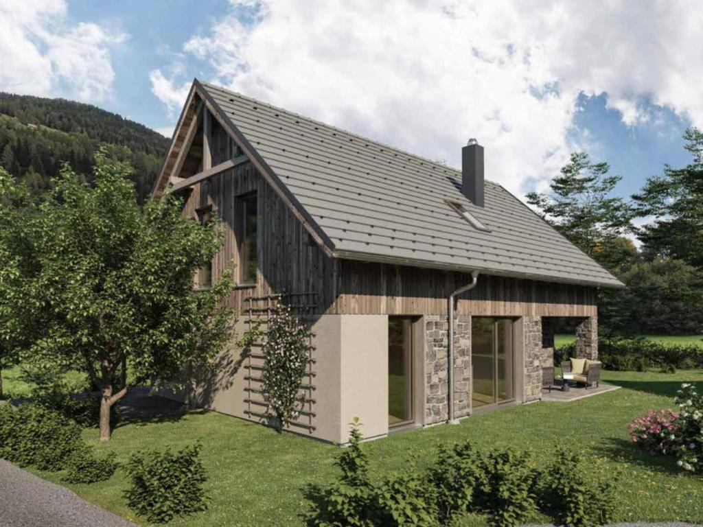 una pequeña casa con techo de gambrel en Mountain Chalet Alpinchique 2, en Sankt Lorenzen ob Murau