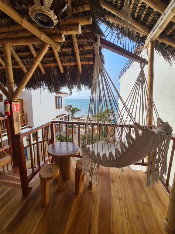 a hammock in a room with a view of the ocean at Intiquilla Hotel in Manta