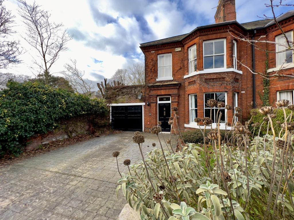 a brick house with a driveway in front of it at Stylish 4 bed house with parking in central Norwich in Norwich