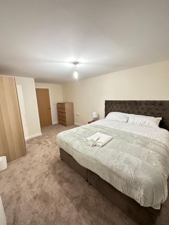 a bedroom with a large bed with a white blanket at Pier Road in London