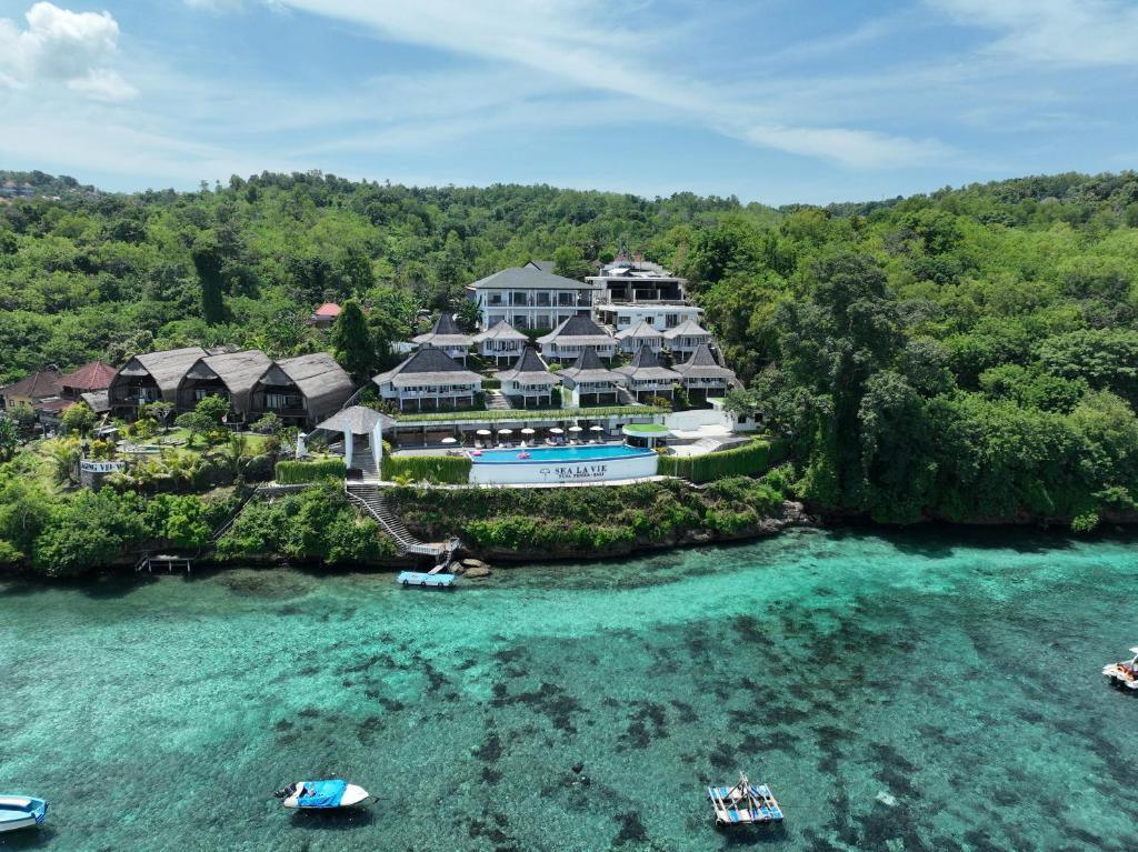 an aerial view of a resort with boats in the water at Sea La Vie Resort Nusa Penida in Nusa Penida
