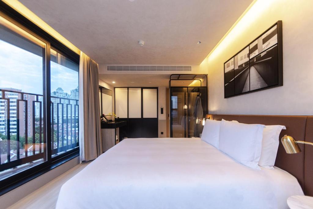 Postel nebo postele na pokoji v ubytování Mia Hotel - Shanghai Shaanxi South Road
