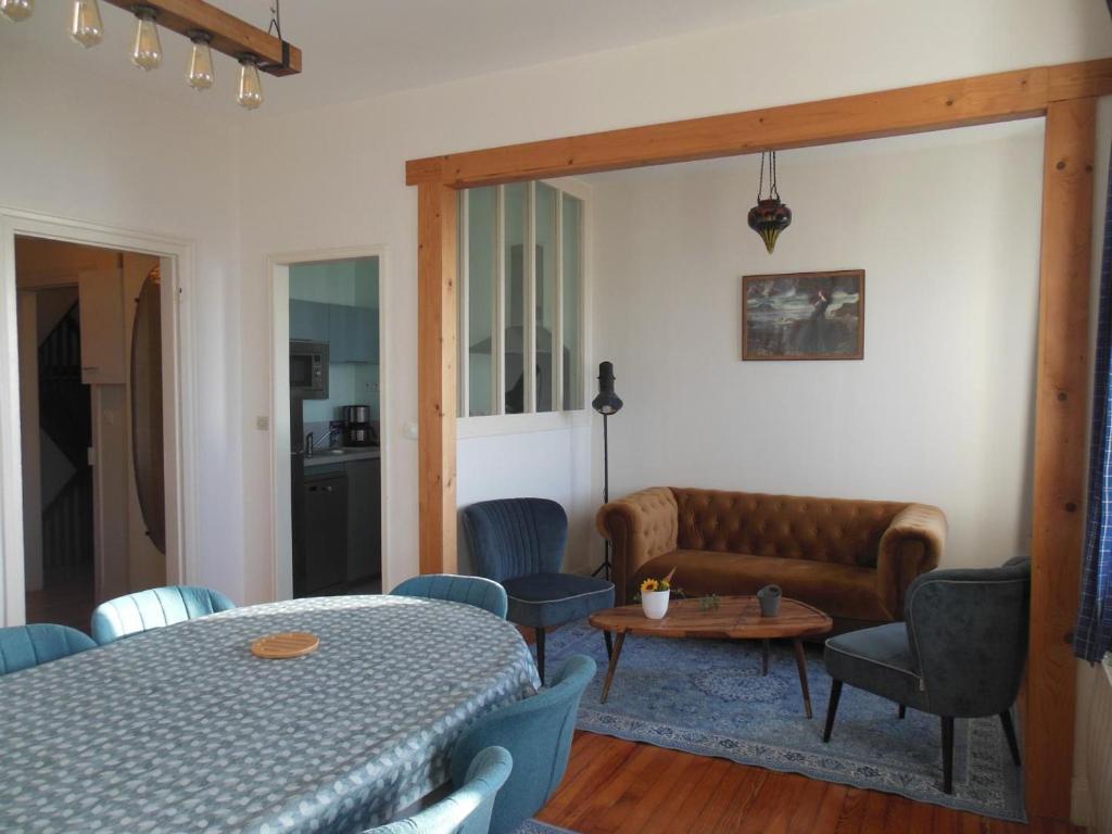 a living room with a table and a couch at Duplex face plage avec terrasse, 3 ch, 2 sdb, WiFi, ménage inclus - FR-1-376-113 in Boulogne-sur-Mer