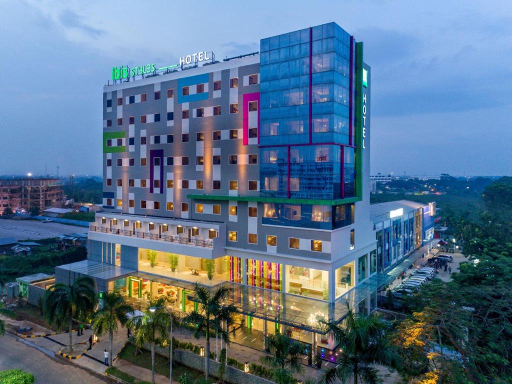 a tall building with lights on in a city at ibis Styles Cikarang in Cikarang