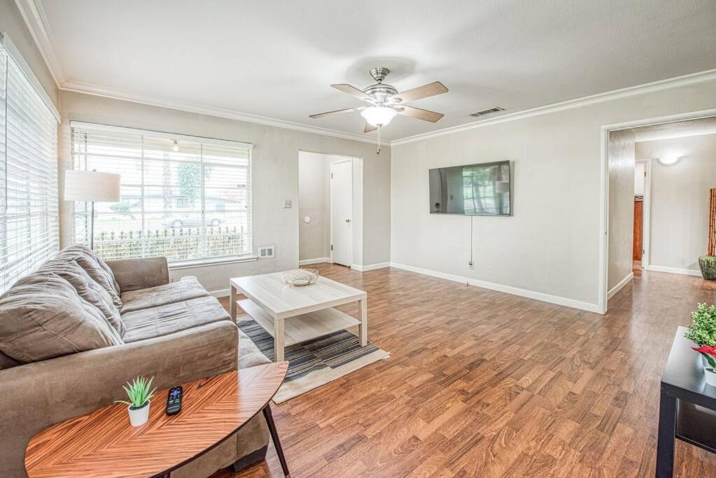 a living room with a couch and a table at Renovated home minutes from Fresno State / Airport in Fresno
