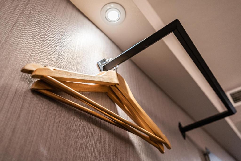 a pair of wooden sticks hanging from a mirror at Global Traveler Hotel in Kaohsiung