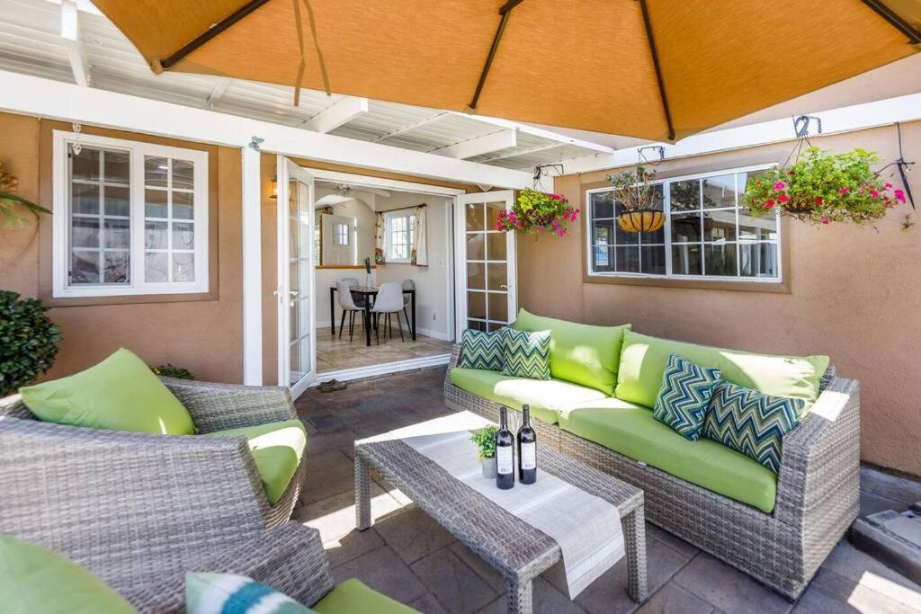 a patio with two couches and a table at Hot Tub . Near Freeway . Quick 2 Theme Parks/Beach in Huntington Beach