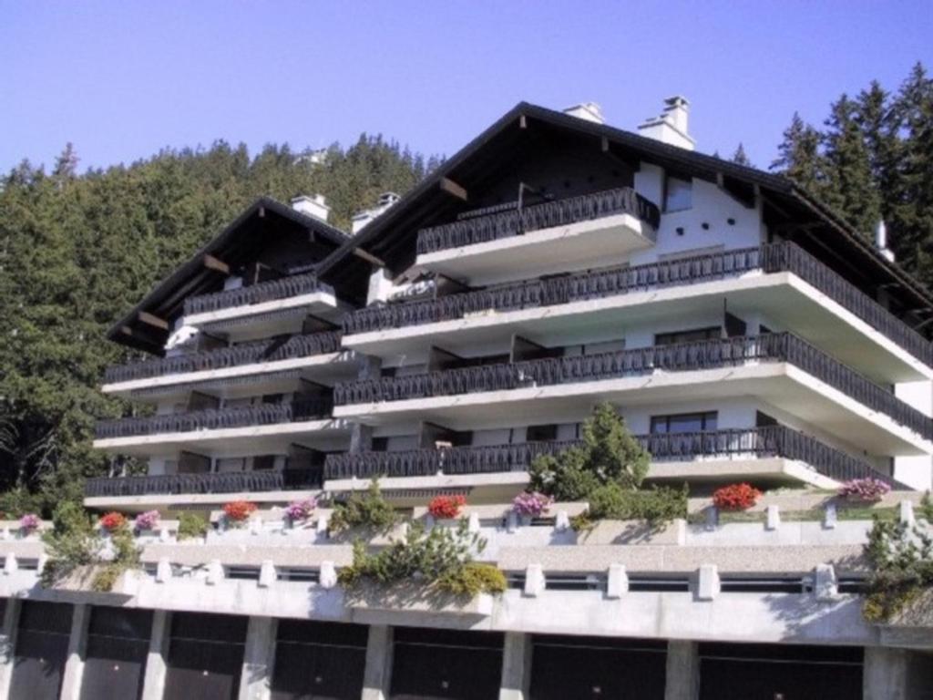a building with balconies on the side of it at Residence Mandarin in Crans-Montana