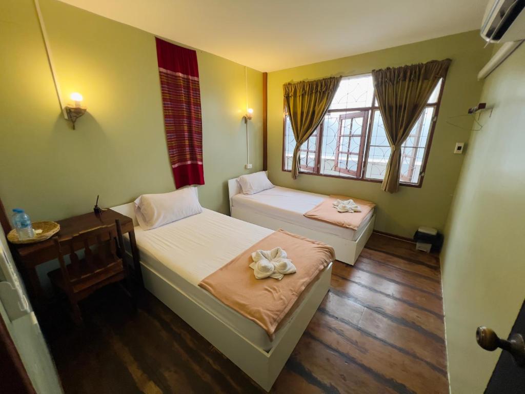 Postel nebo postele na pokoji v ubytování DonMueang Boutique House DonMueang Airport