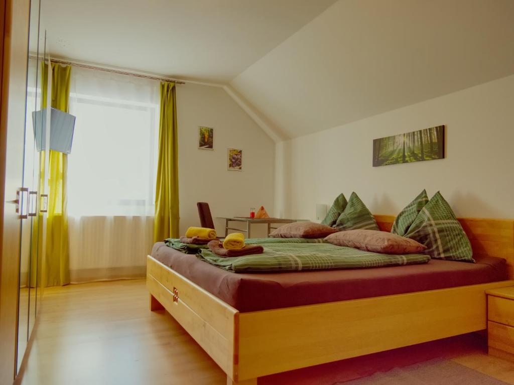 a bedroom with a large bed with a wooden frame at Gasthof zum Postwirt in Predlitz