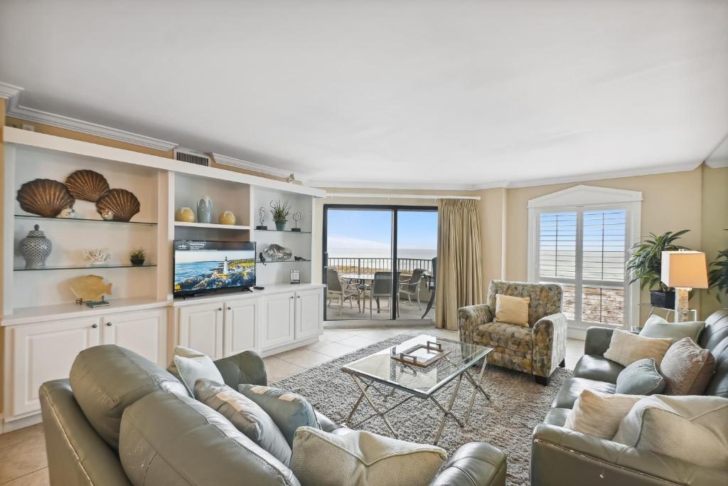 a living room with a couch and a tv at Inlet Reef 102 Destin Condo in Destin