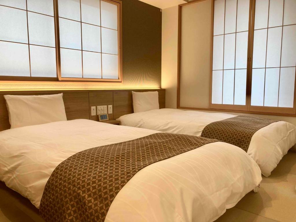 Postel nebo postele na pokoji v ubytování Dormy Inn Premium Ginza