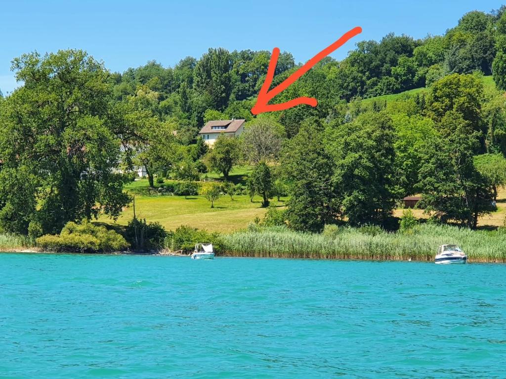 two boats on a lake with a red x at Ferienhaus Bellevue in Öhningen