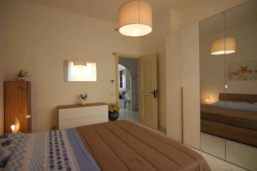 a bedroom with a large bed and a bathroom at Il Nido di Marco a due passi dal mare in Portovenere