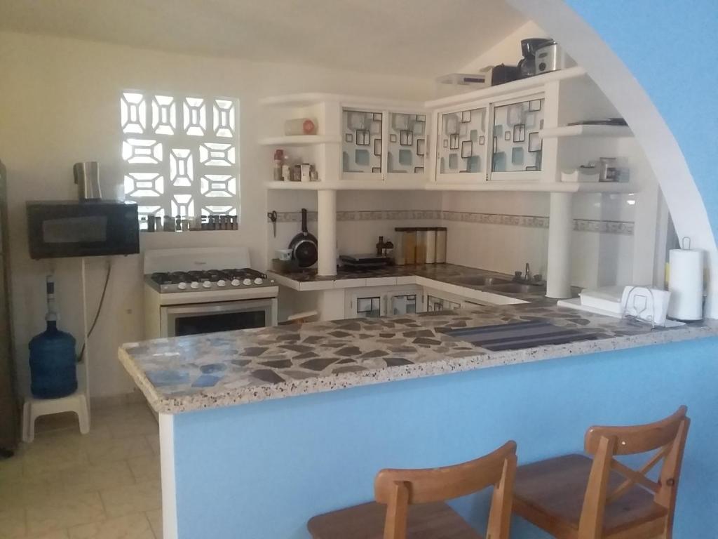 a kitchen with a counter with a stove top oven at Room in Guest room - Best bed and breakfast in Samana Breakfast Included in Santa Bárbara de Samaná