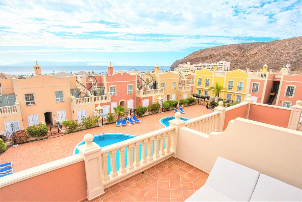 a view from the balcony of a house with a pool at luxury duplex apartment with beautiful sea views in Palm-mar