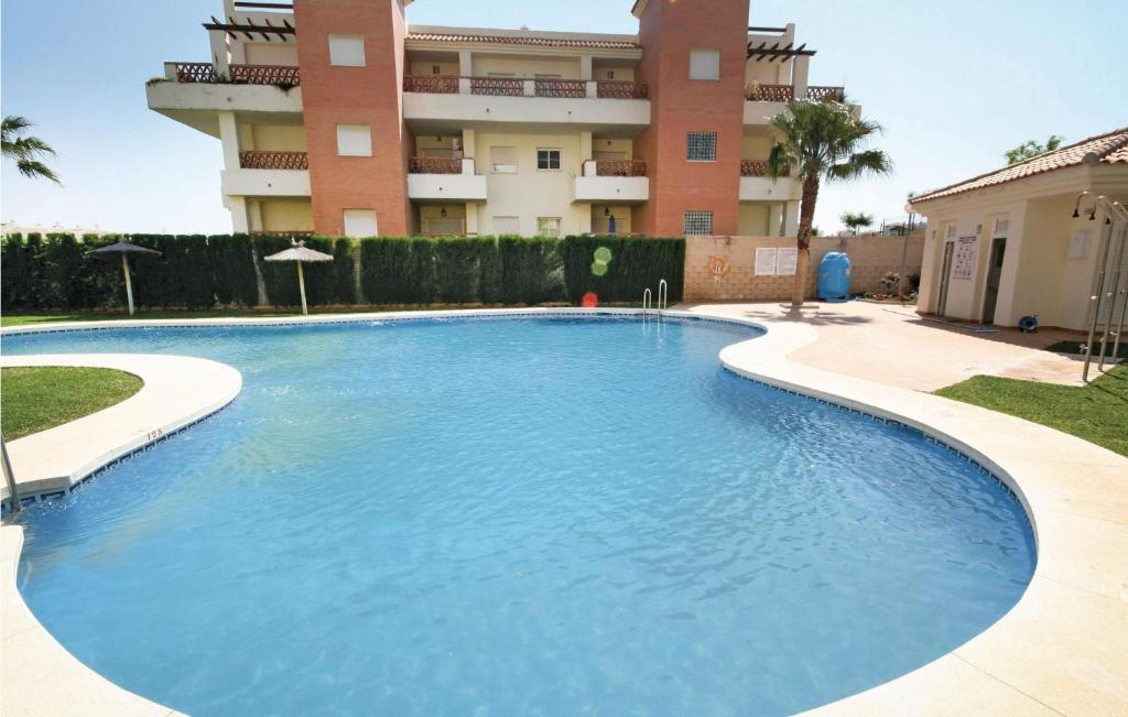 a large swimming pool in front of a building at Nice Apartment In Benalmádena Costa in Benalmádena