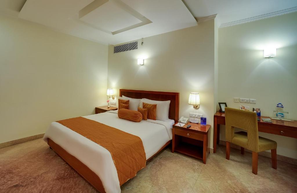 Postel nebo postele na pokoji v ubytování Royal Sarovar Portico Siliguri