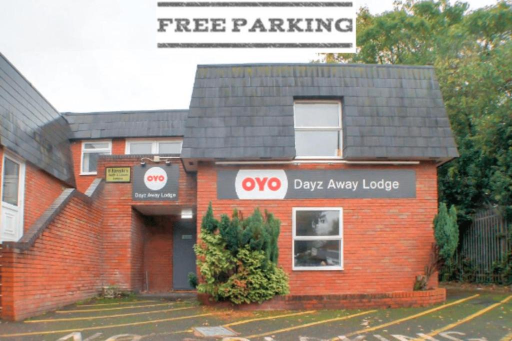 a red brick building with a dogasy lodge at OYO Dayz Away Lodge in Dudley