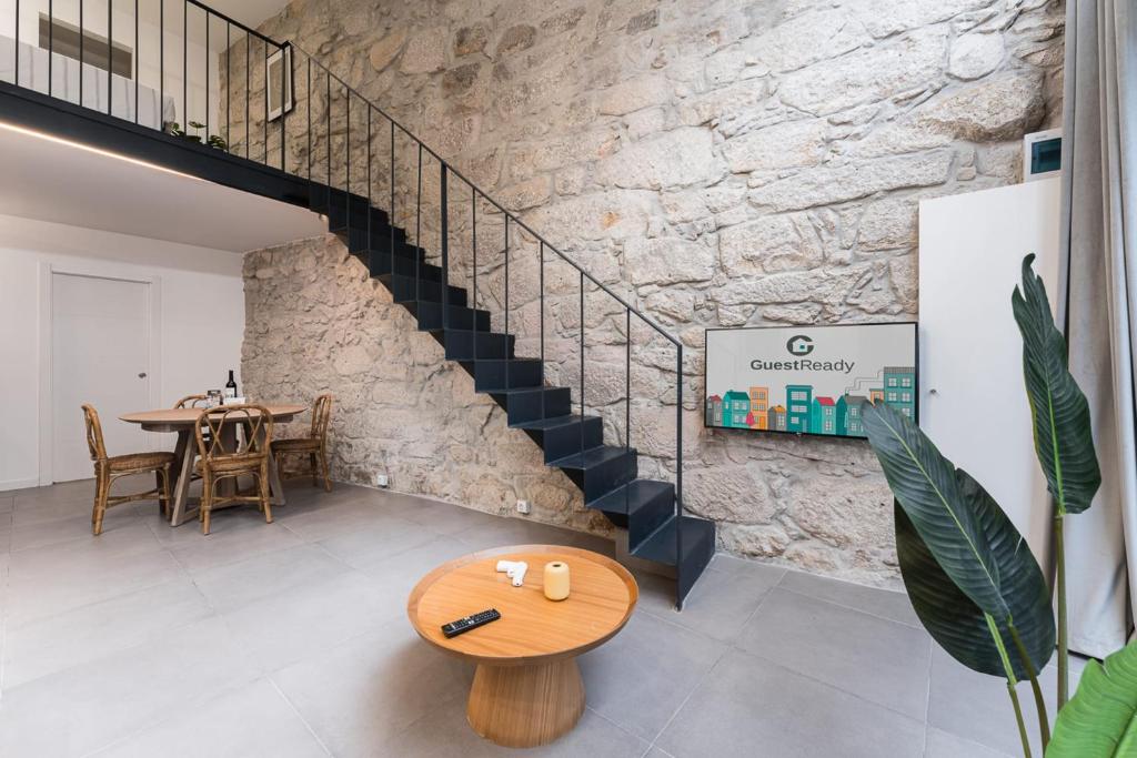 a staircase in a room with a table and a bench at GuestReady - Casa da Alegria 8 in Porto
