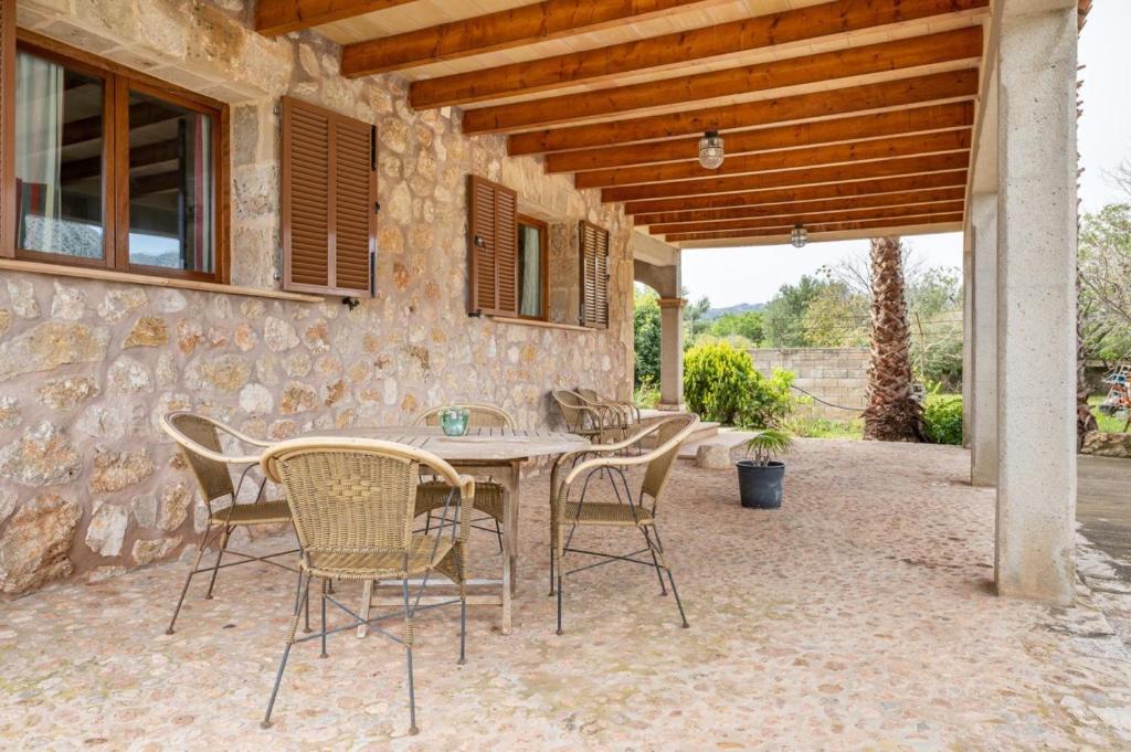 a wooden table and chairs on a patio at Can Jaume in Pollença