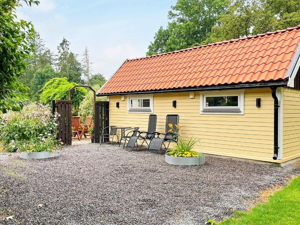a yellow tiny house with an orange roof at 4 person holiday home in FÄRLÖV-By Traum in Färlöv