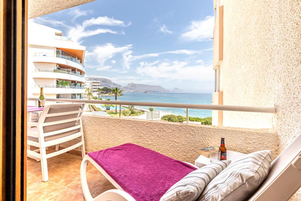 a balcony with a chair and a view of the ocean at Altea Sol in Altea