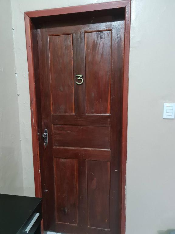 a wooden door with the number five on it at Pousada Meireles Praia in Fortaleza