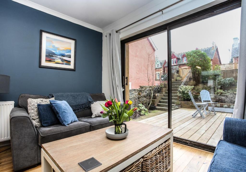 a living room with a couch and a large window at Seahaven in North Berwick