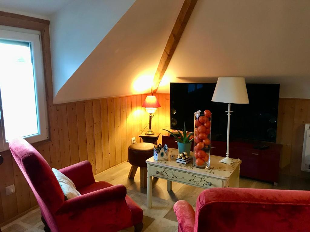 a living room with two chairs and a table at Appartement Cosy Chelles in Chelles