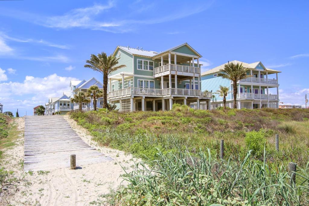 uma casa na praia com um calçadão de madeira em Kathie's Beachfront Kottage em Galveston