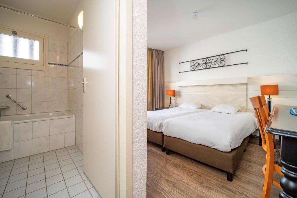 Postel nebo postele na pokoji v ubytování Fletcher Hotel Apeldoorn