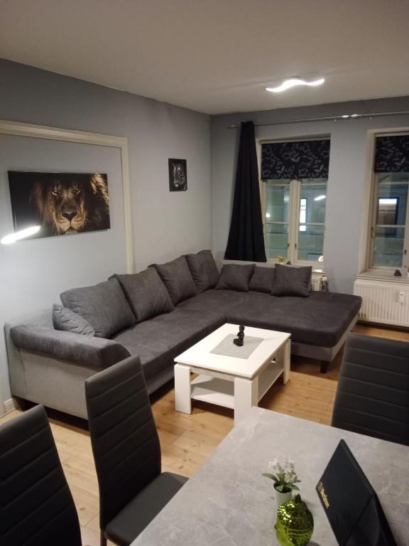 a living room with a couch and a table at Flensburg Zentrum 10 VH 2OG R in Flensburg