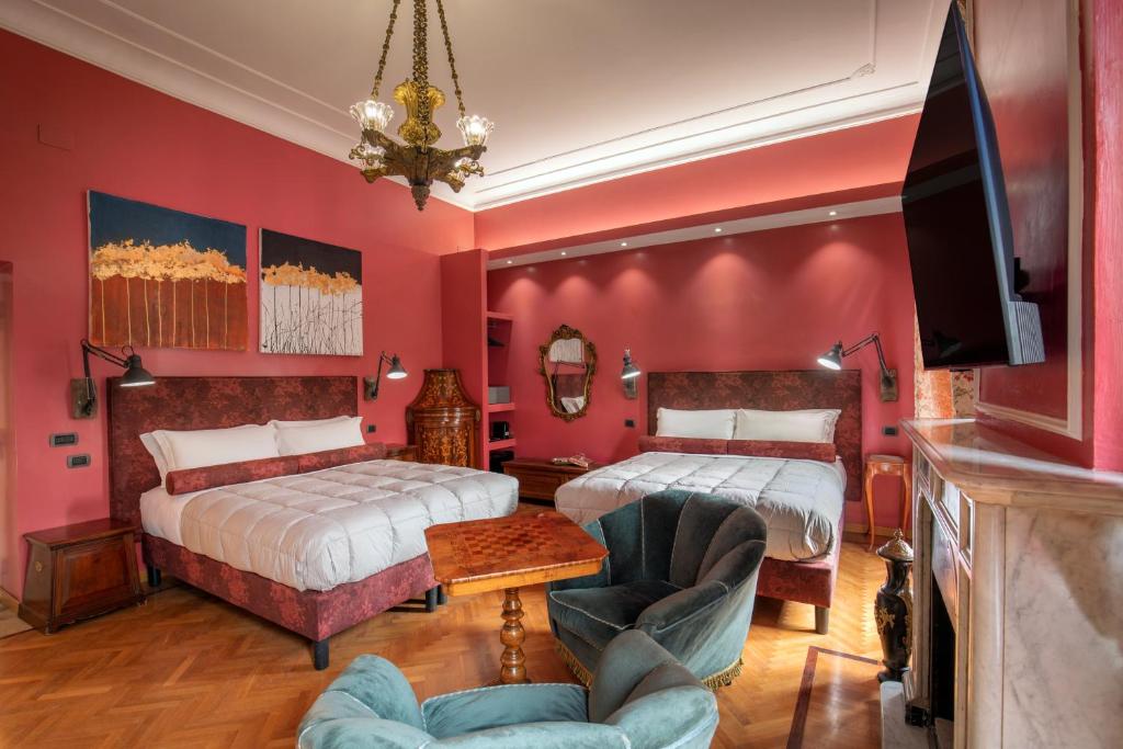 a bedroom with two beds and a tv and a couch at Room 94 Luxury in Rome