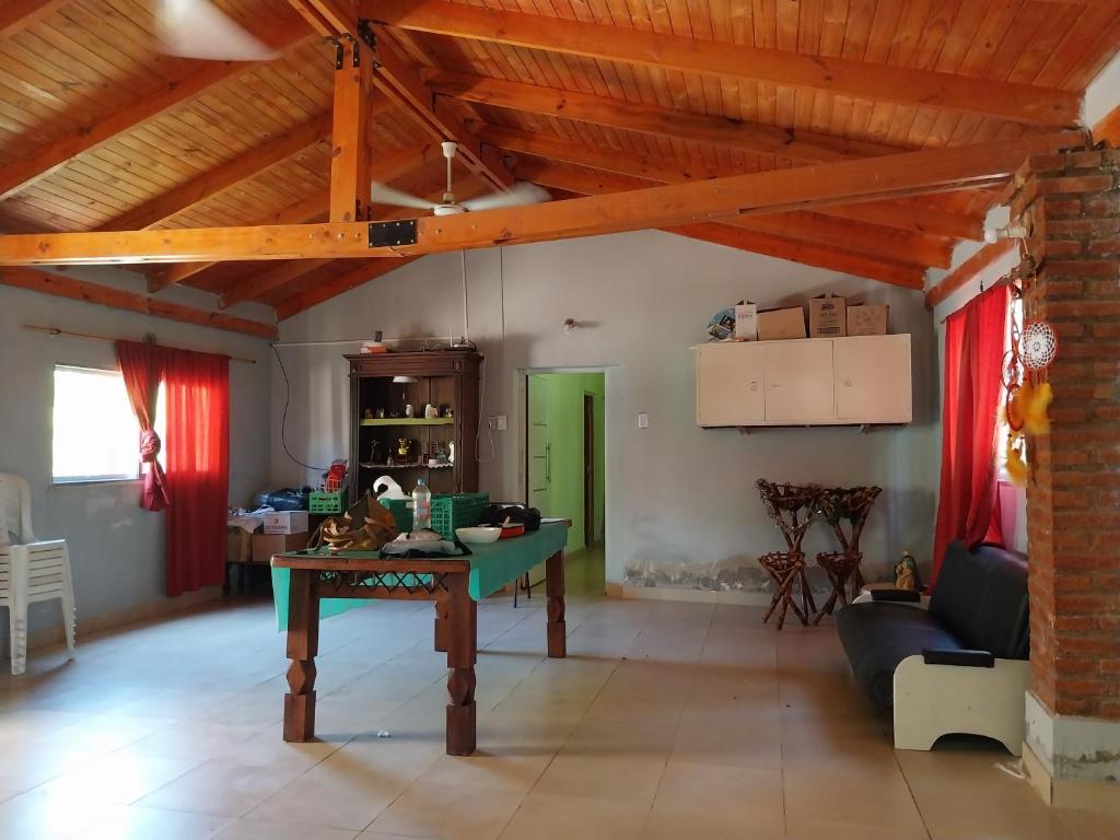 a living room with a table in the middle at BRISAS DEL RIO in Santiago del Estero