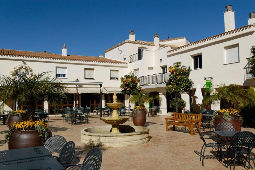 a courtyard with a fountain in front of a building at La Manga Club Resort - Bellaluz 4 in Atamaría