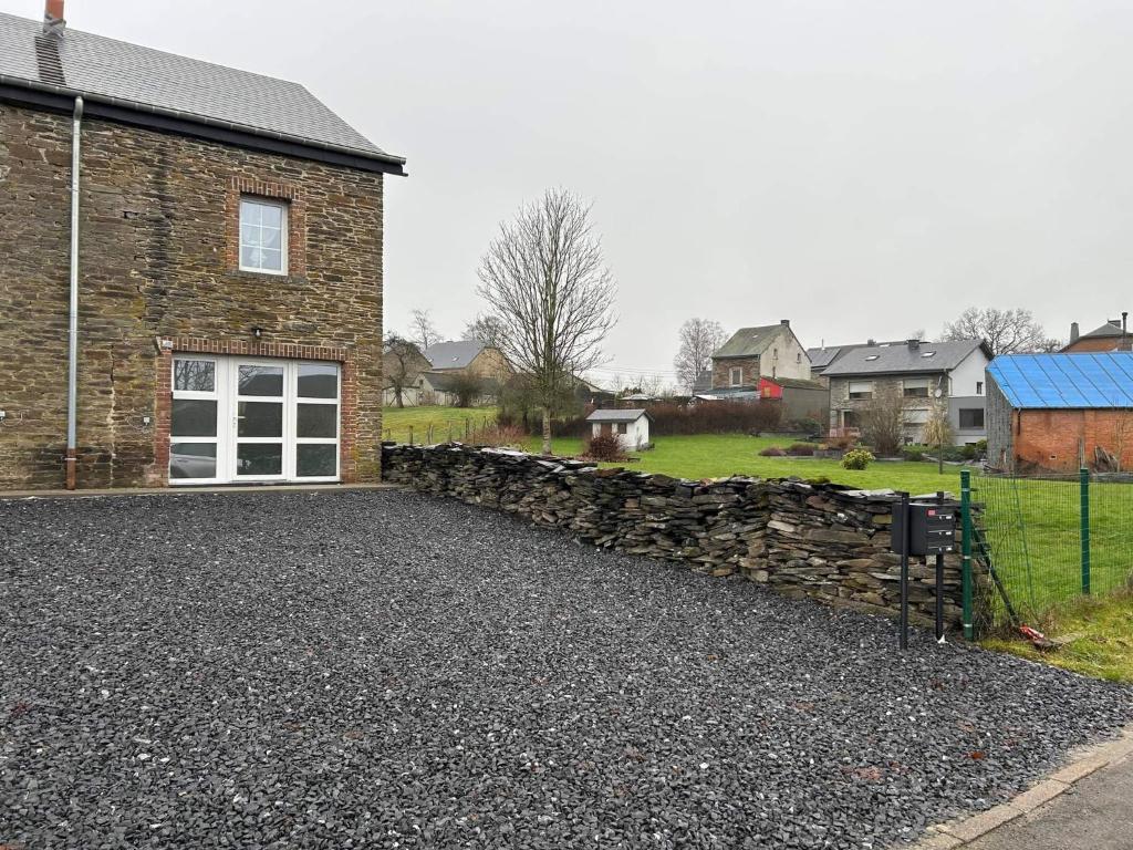 a stone driveway in front of a house at Chez Gina in Herbeumont