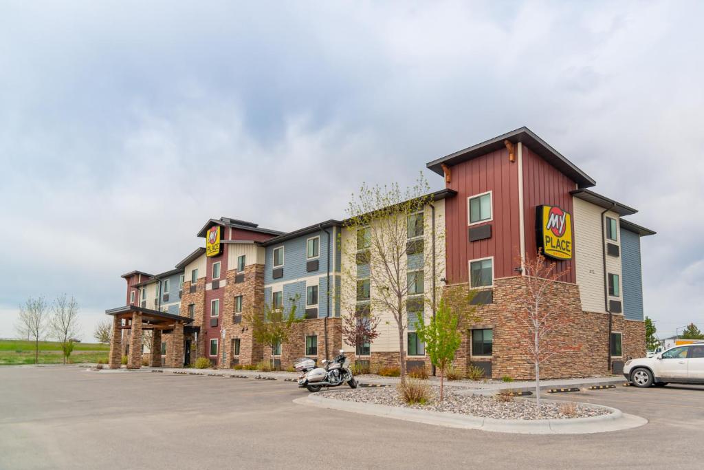 a row of apartment buildings in a parking lot at My Place Hotel-Billings, MT in Billings