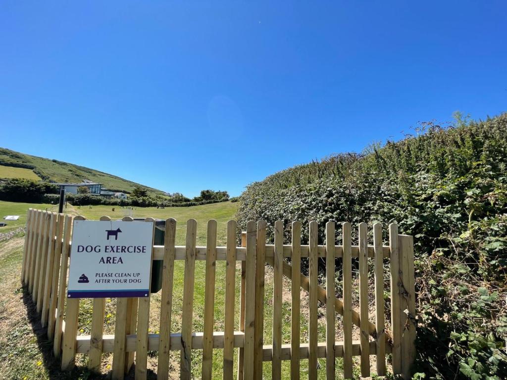 a dog fence with a dog attack sign on it at Croyde Bay Hotel or Self Catering in Croyde