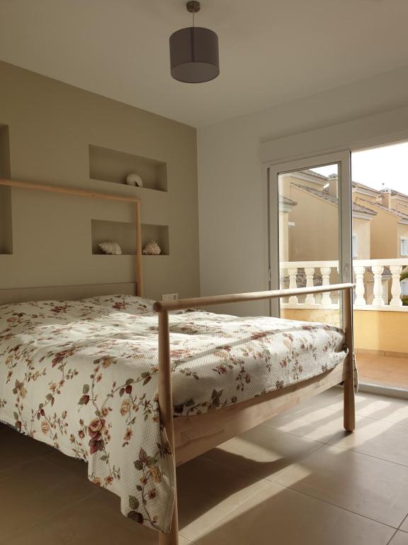 a bedroom with a bed in a room with a window at VILLA DE SUABIA, Casa 9 in San Fulgencio