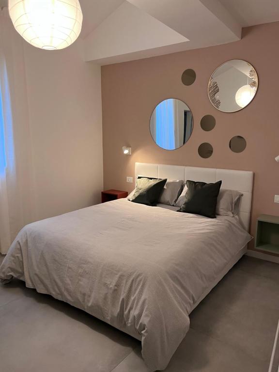 una camera da letto con un grande letto con due specchi sul muro di Quiet Room a Bologna