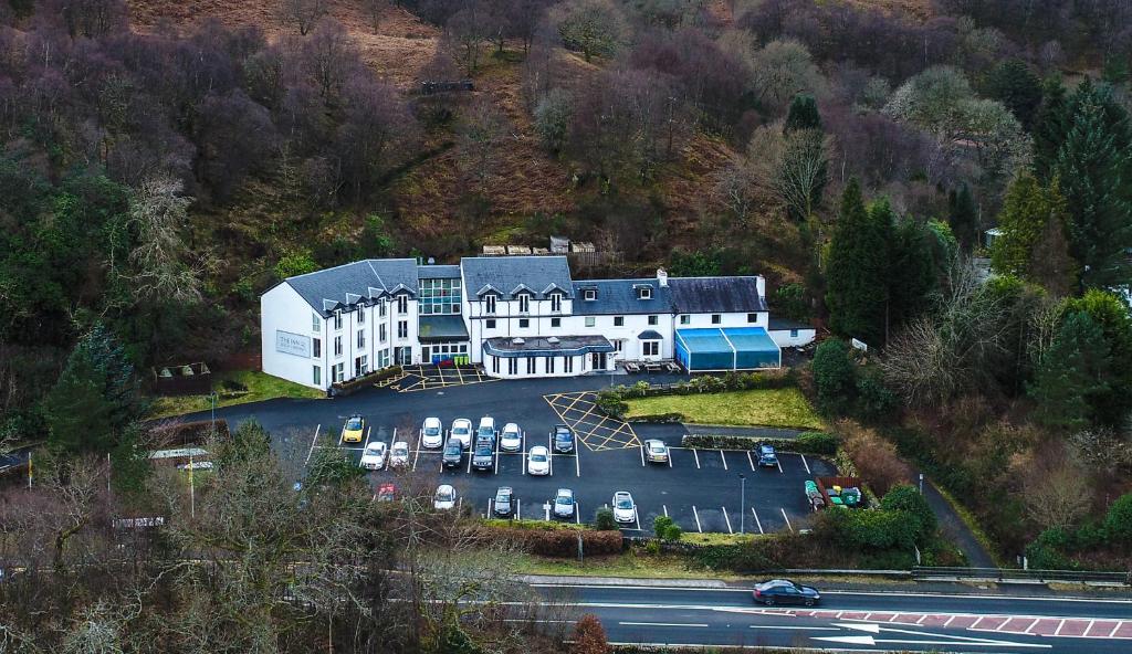 an aerial view of a building with a parking lot at The Inn on Loch Lomond in Luss