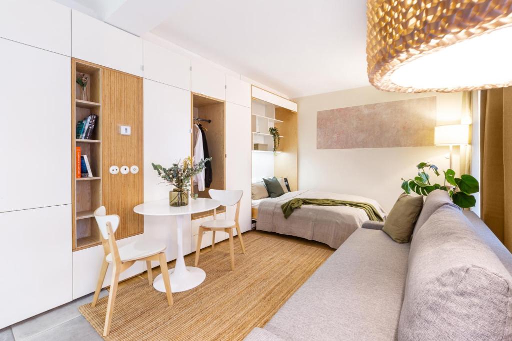 a living room with a couch and a table at TurnKey I Studio by Amazing Park in Prague