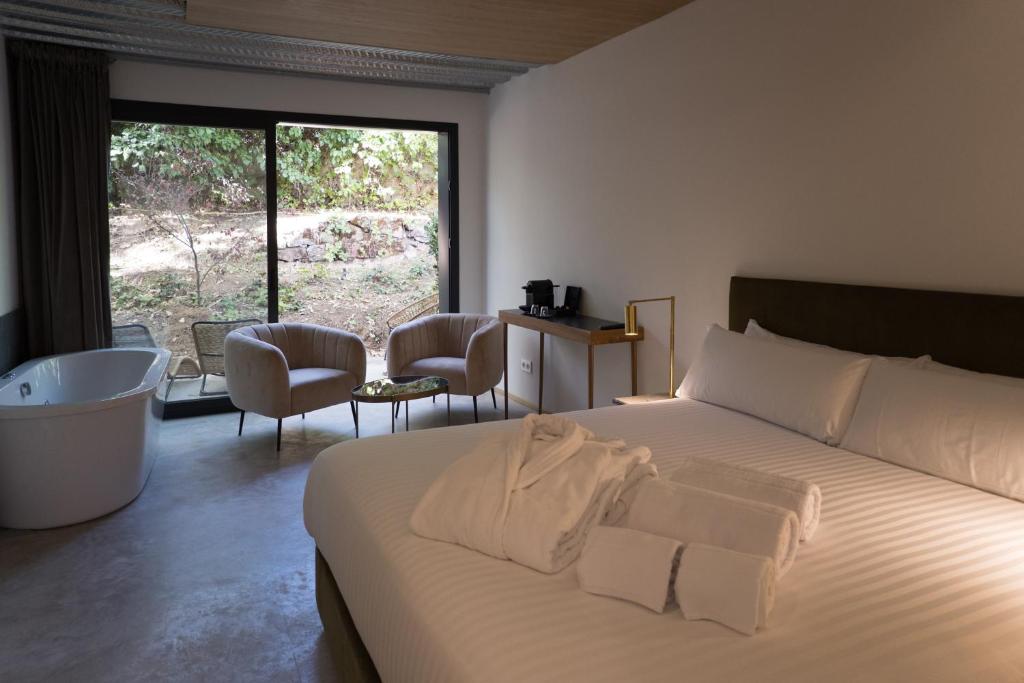 a bedroom with a large bed and a large window at BOX ART ALPINO in Navacerrada