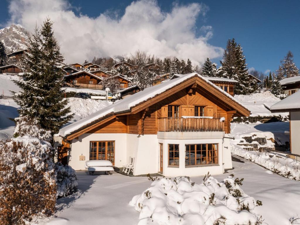 a log cabin in the snow with snow covered trees at Chalet Six des Armailles by Interhome in Ovronnaz