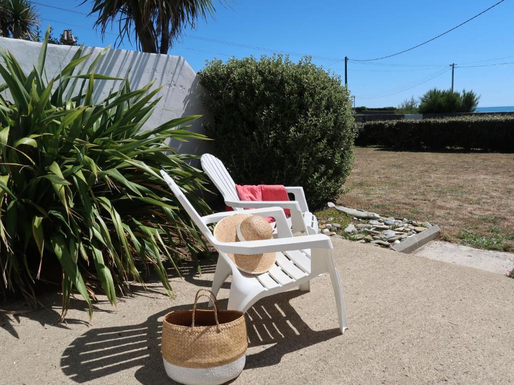PlozévetにあるHoliday Home Rendez-vous à la plage - PZV101 by Interhomeの白い芝生の椅子2脚(帽子、バスケット付)