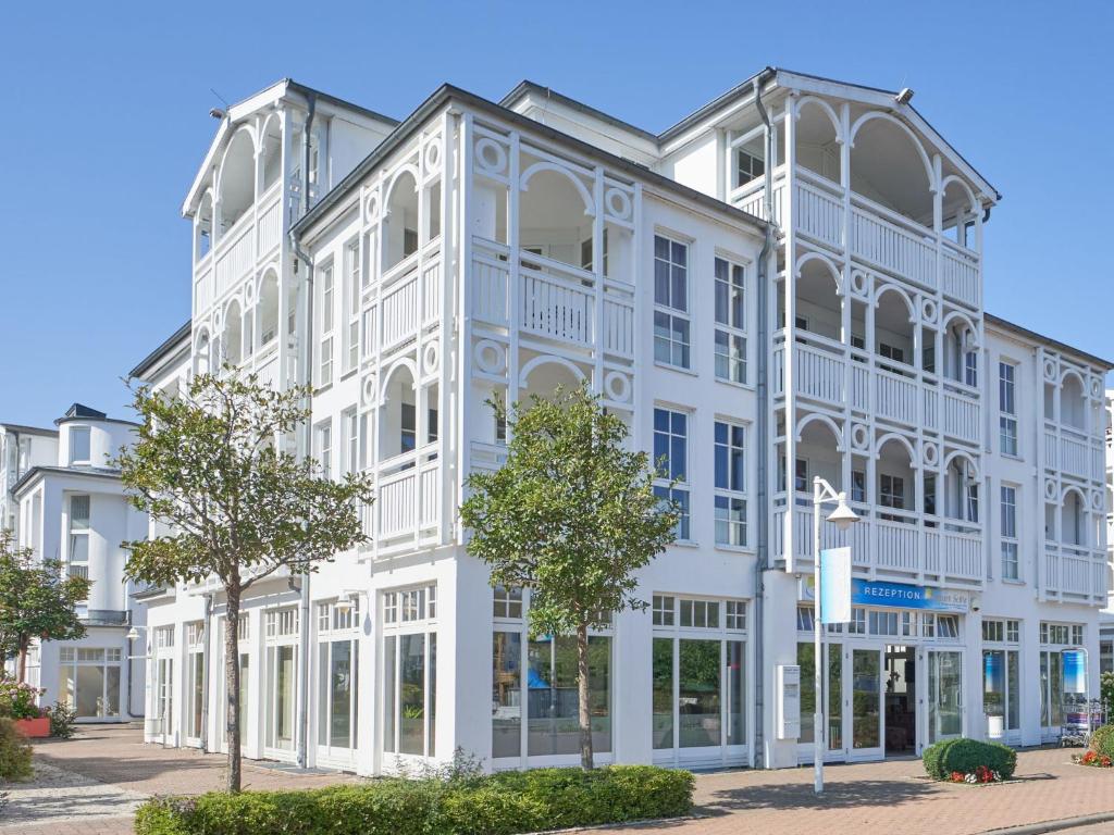 a large white building with white trim at Apartment Seepark Sellin-2 by Interhome in Ostseebad Sellin
