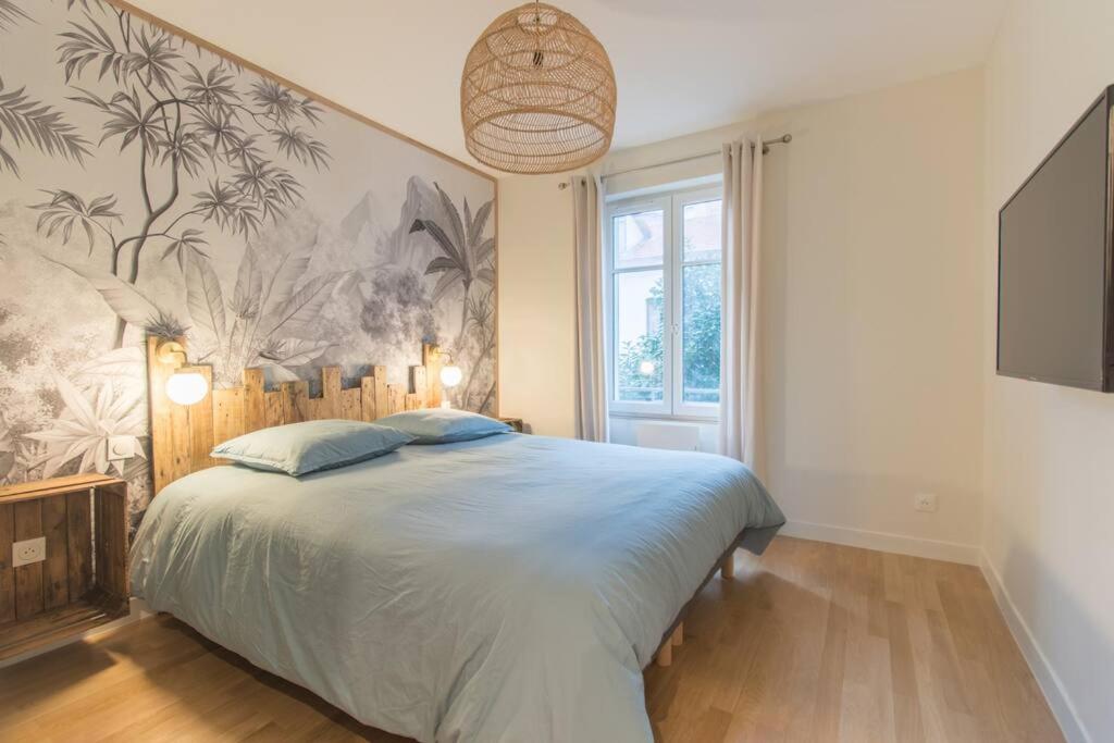 a bedroom with a large bed and a large window at T3 rénové 10min gare Part dieu - Quartier typique in Lyon